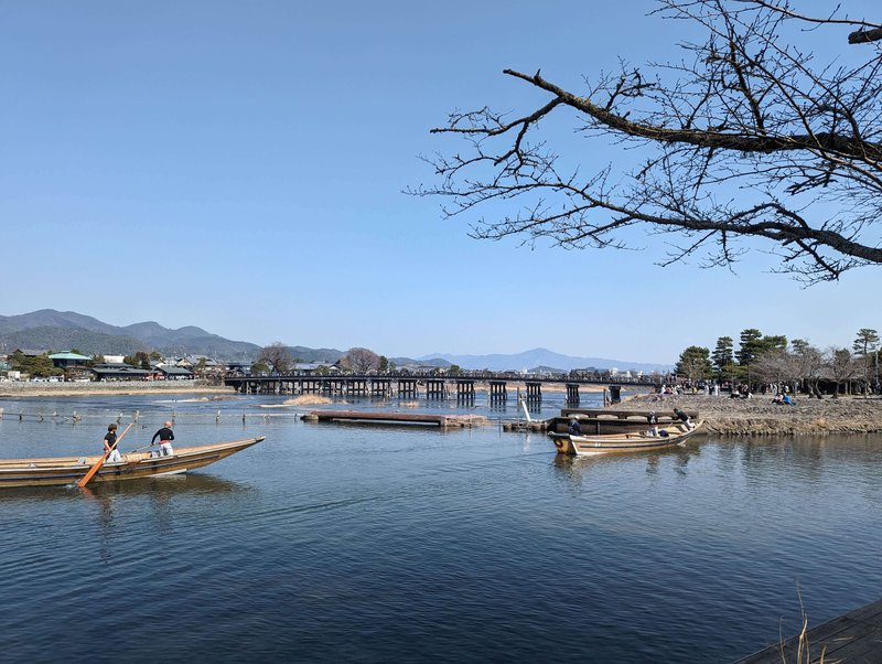lake with boats near togetsukyo bridge